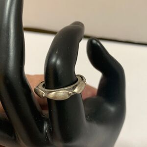 Size 7 silvertone ring with stamp “KC” inside.